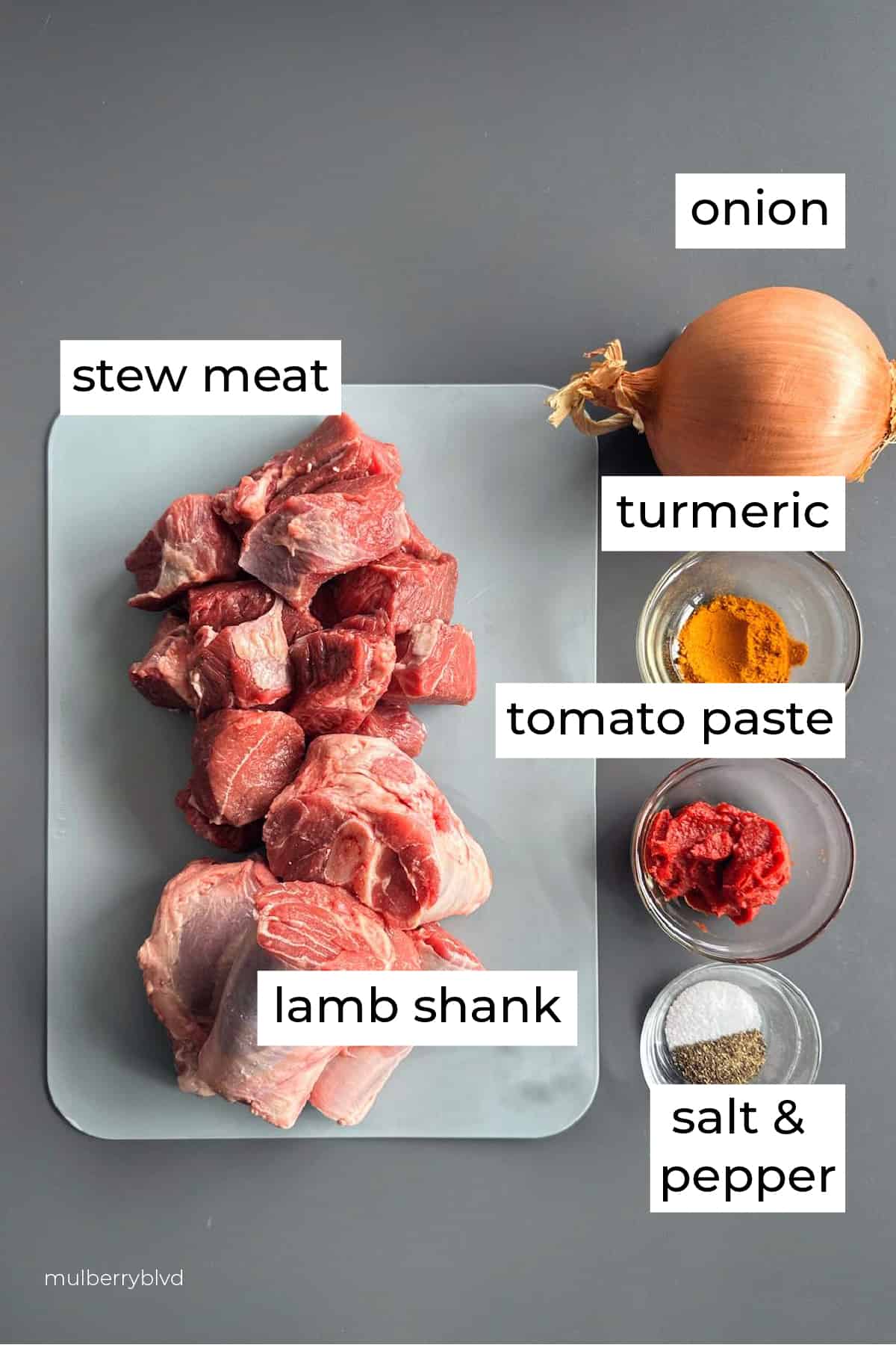Picture of ingredients. Stew meat, lamb shank, onion, turmeric, tomato paste, salt and pepper