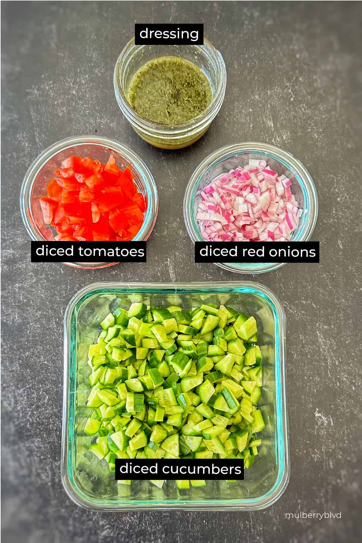 Salad Shirazi ingredients. Dressing, diced tomatoes, diced onions, diced cucumbers