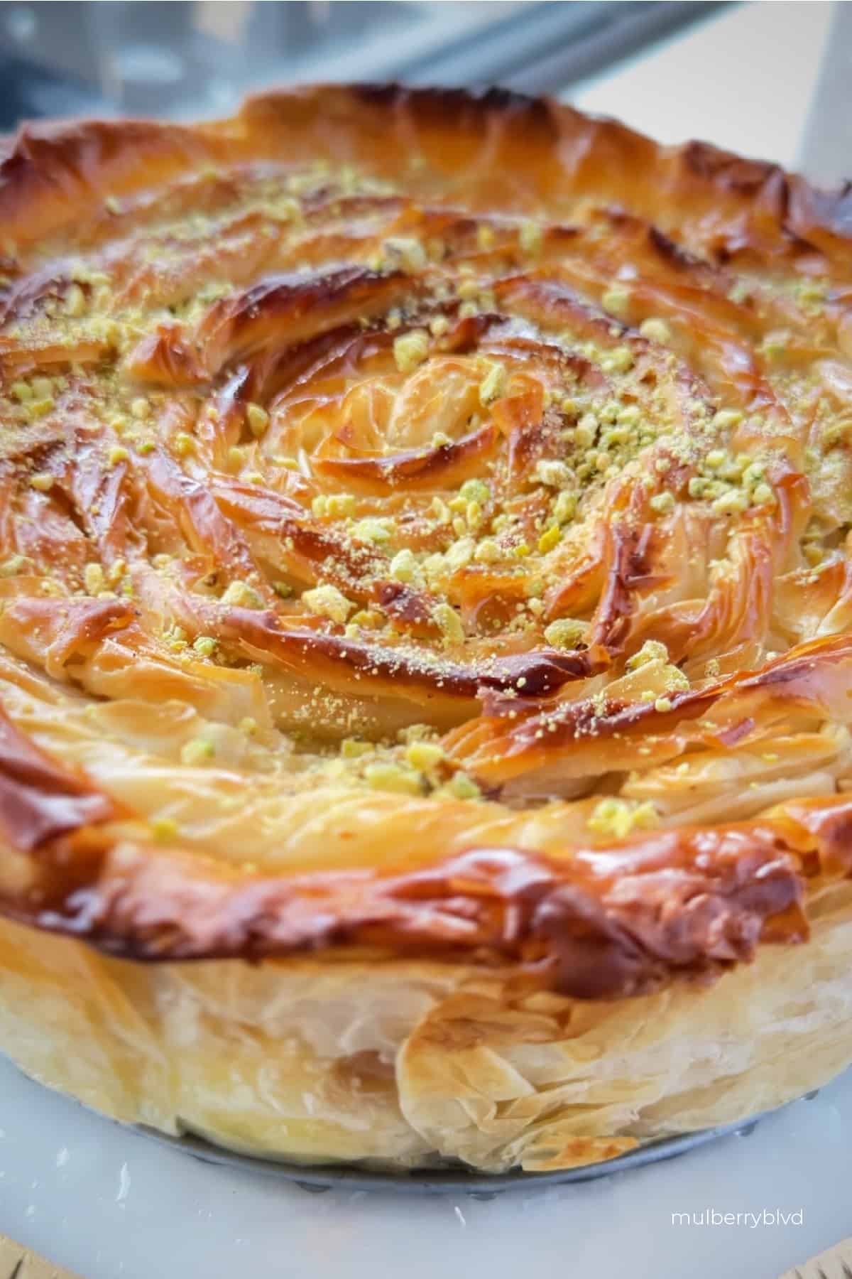 Close up of the flaky crust surround the entire baklava cheesecake