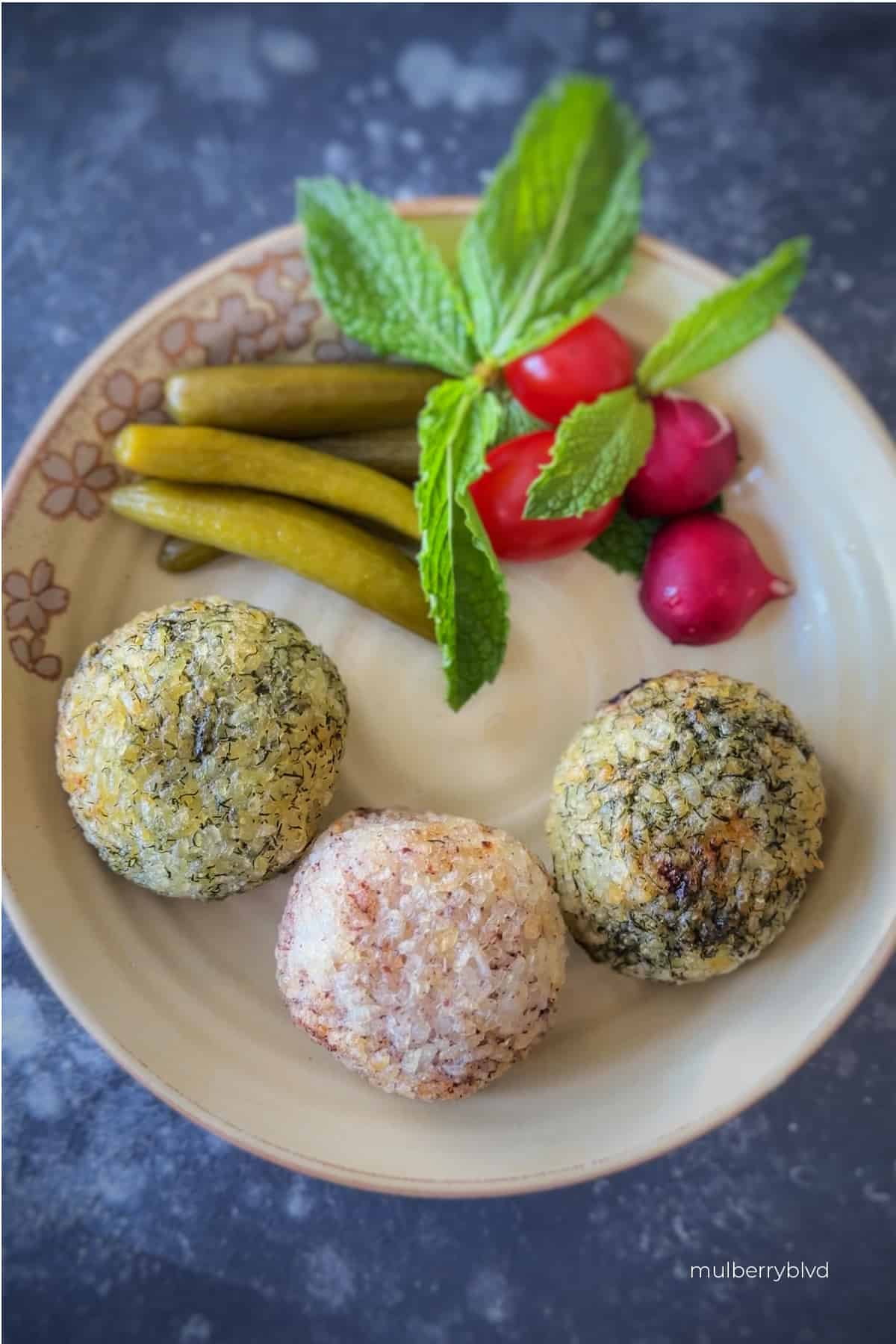 Crispy Tahdig rice balls with garnish on a plate