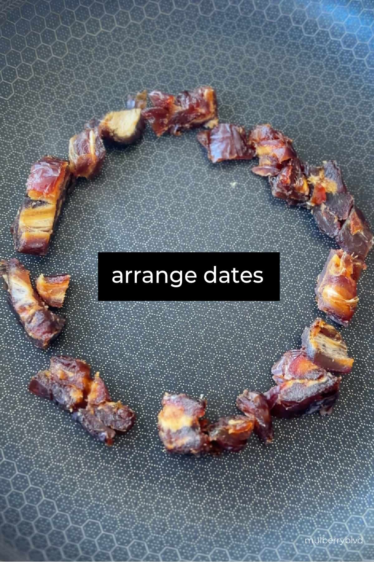 This image shows a pan, with chopped up dates arranged in a circle. The text says "arrange dates".